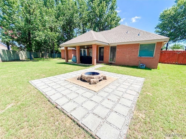 7908 Arrowhead Forest Ct, Montgomery, AL 36117 - rear view of house with a patio area, a fire pit, brick siding, a fenced backyard, and a shingled roof