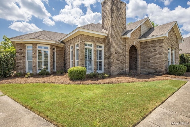 8872 Old Magnolia Way, Montgomery, AL 36116 - view of front of home featuring brick siding, a front lawn, a chimney, and a shingled roof