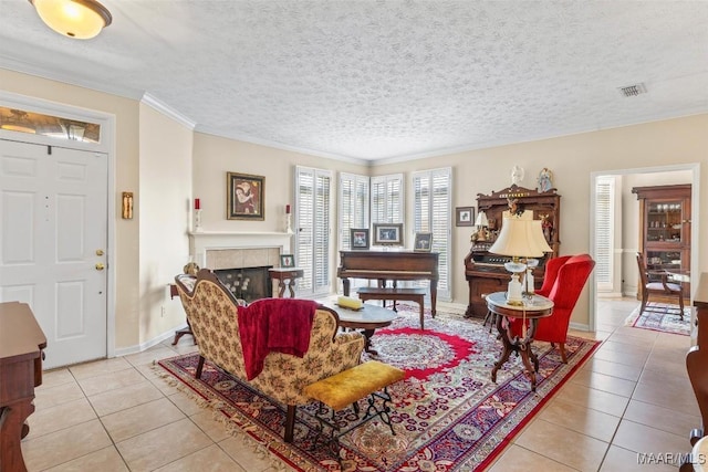 8872 Old Magnolia Way, Montgomery, AL 36116 - living room with light tile patterned flooring, a tiled fireplace, crown molding, and a textured ceiling
