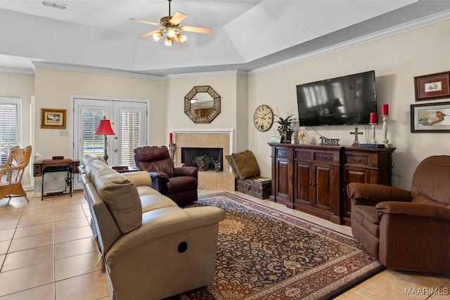 8872 Old Magnolia Way, Montgomery, AL 36116 - living area with light tile patterned flooring, ceiling fan, plenty of natural light, crown molding, and a tiled fireplace