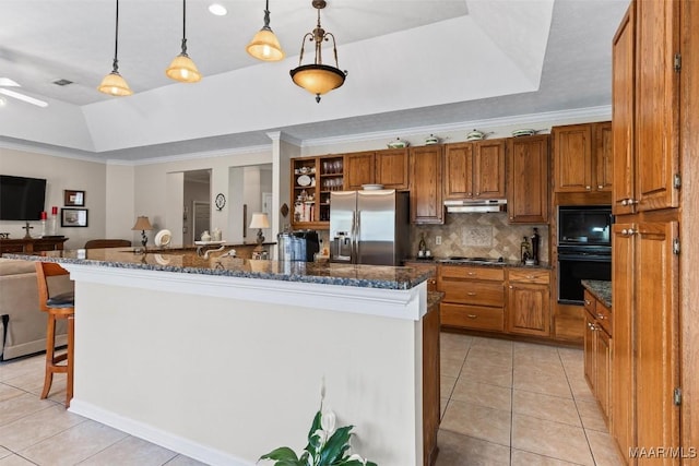 8872 Old Magnolia Way, Montgomery, AL 36116 - kitchen featuring appliances with stainless steel finishes, a raised ceiling, under cabinet range hood, light tile patterned flooring, and crown molding