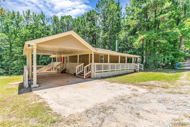 54 Pine Dr, Eclectic, AL 36024 - view of front of house featuring covered porch, concrete driveway, and a front lawn