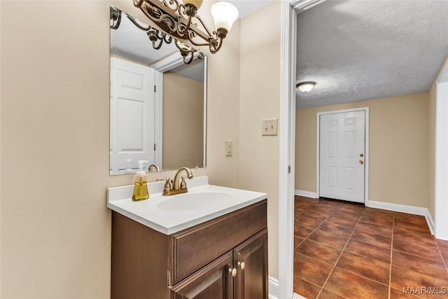 54 Pine Dr, Eclectic, AL 36024 - bathroom with vanity, tile patterned flooring, a chandelier, and a textured ceiling