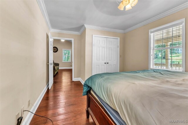 54 Pine Dr, Eclectic, AL 36024 - bedroom with dark wood-style flooring, crown molding, a closet, and a ceiling fan
