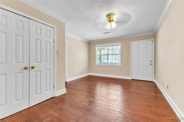 54 Pine Dr, Eclectic, AL 36024 - unfurnished bedroom with wood finished floors, a textured ceiling, crown molding, ceiling fan, and a closet