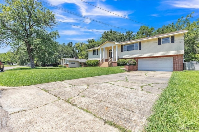 1422 Flamingo Ln, Montgomery, AL 36116 - split foyer home with driveway, brick siding, a garage, and a front lawn