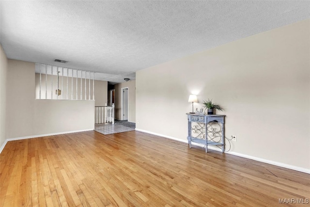 1422 Flamingo Ln, Montgomery, AL 36116 - unfurnished living room with wood finished floors and a textured ceiling