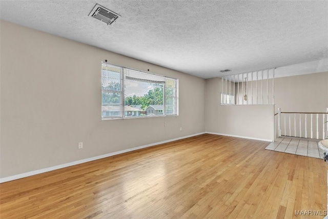 1422 Flamingo Ln, Montgomery, AL 36116 - unfurnished room with a textured ceiling and light wood-style floors