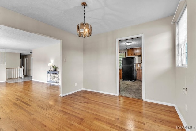 1422 Flamingo Ln, Montgomery, AL 36116 - unfurnished room featuring light wood-style flooring and a chandelier