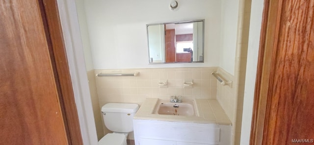 2804 Sumter Ave, Montgomery, AL 36109 - half bathroom with vanity, a wainscoted wall, and tile walls