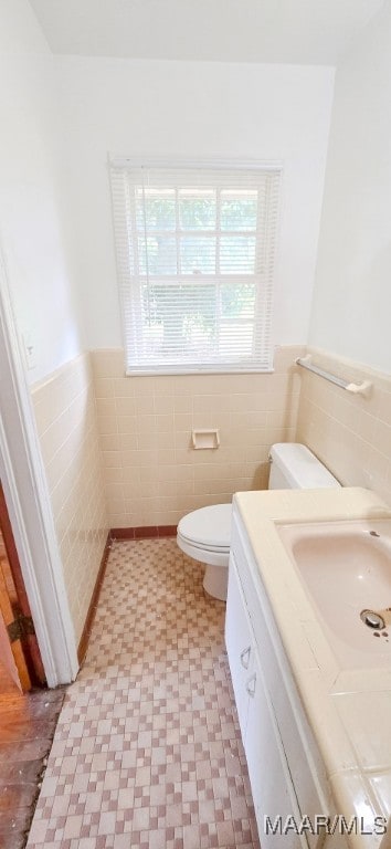 2804 Sumter Ave, Montgomery, AL 36109 - half bathroom with tile walls, healthy amount of natural light, tile patterned floors, wainscoting, and vanity