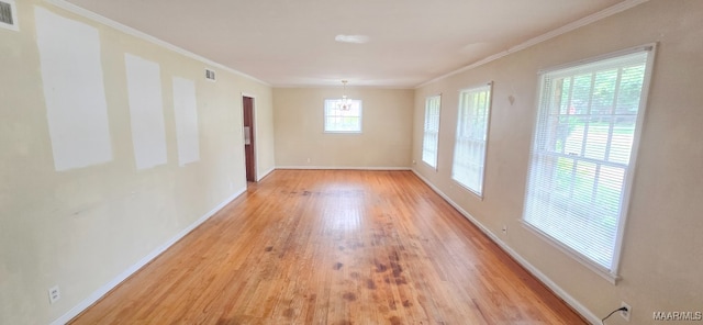 2804 Sumter Ave, Montgomery, AL 36109 - spare room with a chandelier, light wood-style flooring, and crown molding