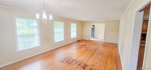 2804 Sumter Ave, Montgomery, AL 36109 - unfurnished room featuring crown molding, a chandelier, plenty of natural light, and light wood-style flooring