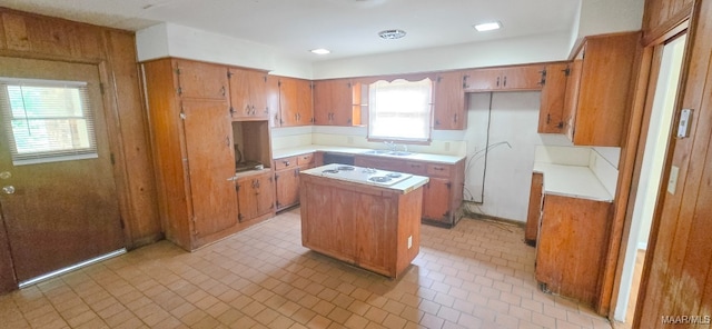 2804 Sumter Ave, Montgomery, AL 36109 - kitchen featuring brown cabinets, light countertops, a kitchen island, and white cooktop