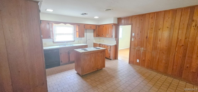 2804 Sumter Ave, Montgomery, AL 36109 - kitchen with a kitchen island, light countertops, wood walls, brown cabinetry, and white electric cooktop