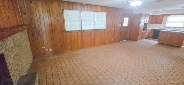 2804 Sumter Ave, Montgomery, AL 36109 - kitchen with a ceiling fan, wooden walls, light countertops, and open floor plan