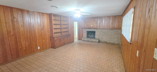 2804 Sumter Ave, Montgomery, AL 36109 - unfurnished living room featuring wooden walls, a brick fireplace, and ceiling fan