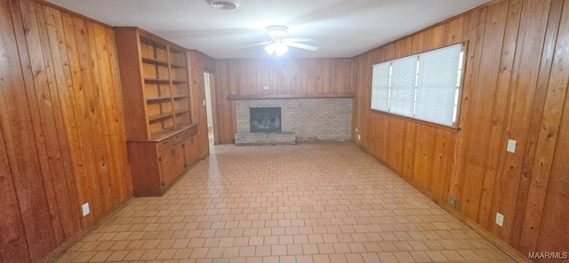 2804 Sumter Ave, Montgomery, AL 36109 - unfurnished living room featuring wooden walls, a brick fireplace, and ceiling fan