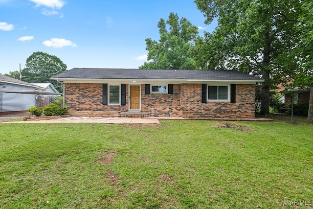 506 Lilly Ave, Tallassee, AL 36078 - ranch-style house featuring brick siding and a front lawn