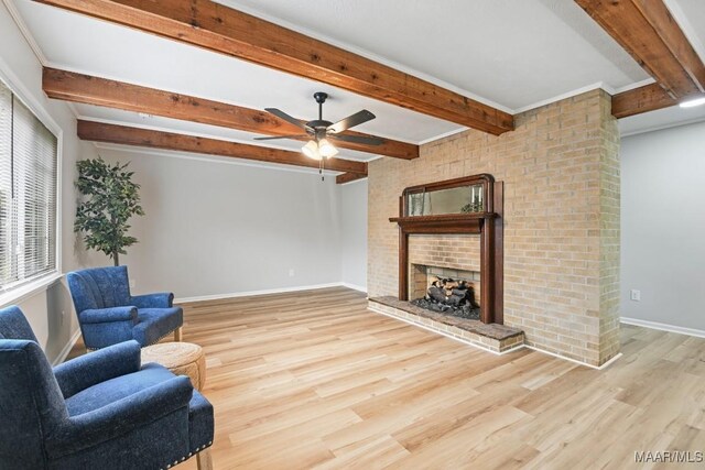 506 Lilly Ave, Tallassee, AL 36078 - living room featuring a fireplace, wood finished floors, a ceiling fan, and beam ceiling