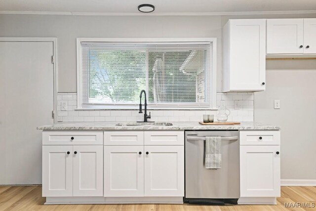 506 Lilly Ave, Tallassee, AL 36078 - kitchen featuring stainless steel dishwasher, white cabinetry, tasteful backsplash, light stone countertops, and light wood-style flooring