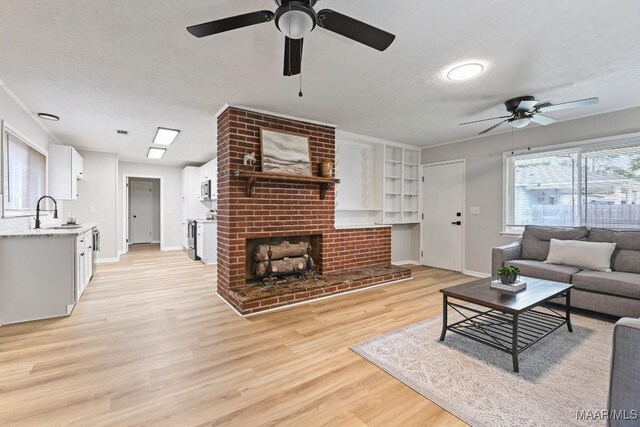 506 Lilly Ave, Tallassee, AL 36078 - living area featuring ceiling fan, light wood finished floors, and a brick fireplace