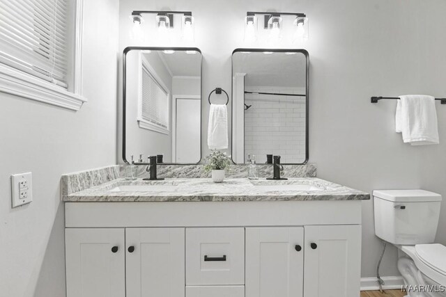 506 Lilly Ave, Tallassee, AL 36078 - bathroom featuring double vanity, a shower, and wood finished floors