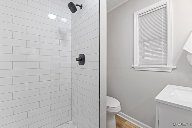 506 Lilly Ave, Tallassee, AL 36078 - full bathroom with a tile shower, vanity, wood finished floors, and crown molding
