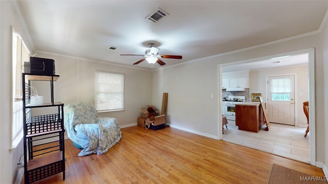 1706 Celia Ct, Montgomery, AL 36106 - sitting room with light wood finished floors, ceiling fan, and ornamental molding
