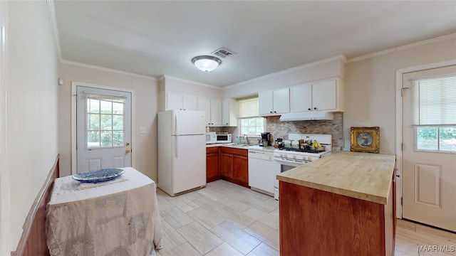 1706 Celia Ct, Montgomery, AL 36106 - kitchen featuring white appliances, under cabinet range hood, decorative backsplash, crown molding, and white cabinetry