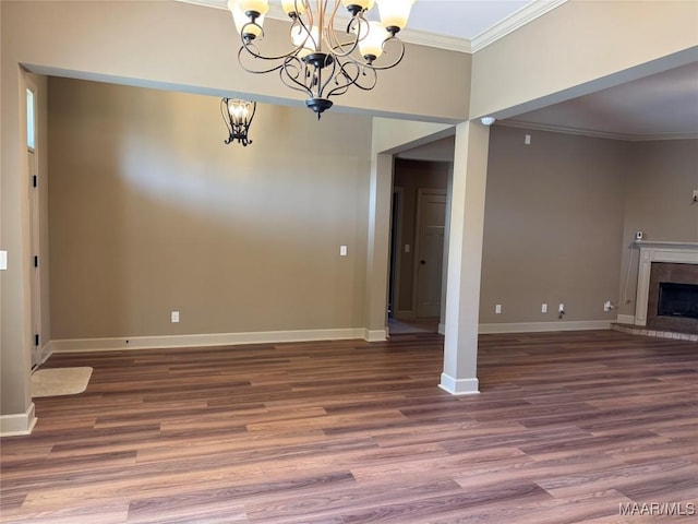 3701 Weston Pl, Montgomery, AL 36116 - unfurnished living room with crown molding, a chandelier, wood finished floors, and a tiled fireplace