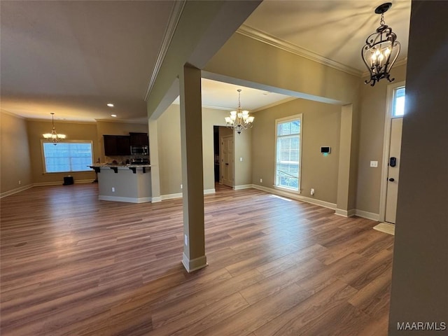 3701 Weston Pl, Montgomery, AL 36116 - unfurnished living room with a chandelier, ornamental molding, healthy amount of natural light, wood finished floors, and recessed lighting