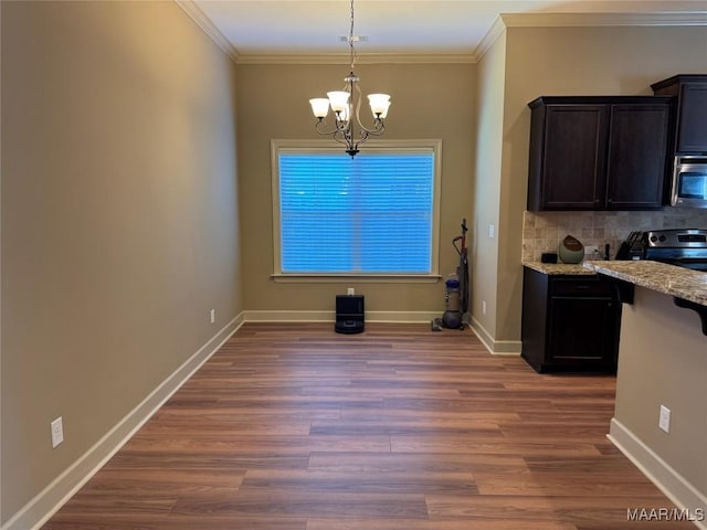 3701 Weston Pl, Montgomery, AL 36116 - unfurnished dining area featuring a chandelier, crown molding, and wood finished floors