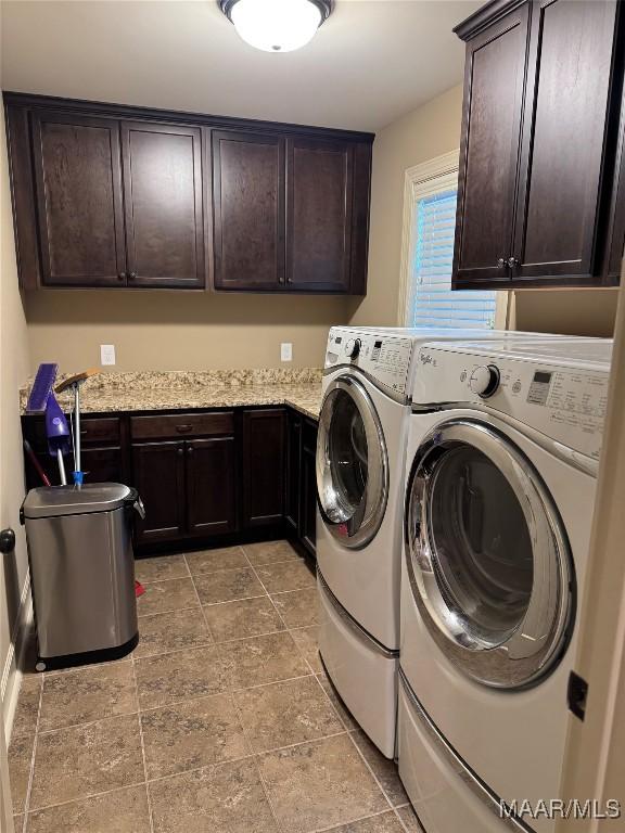 3701 Weston Pl, Montgomery, AL 36116 - washroom with cabinet space, washing machine and dryer, and light stone finish floors