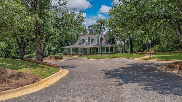 285 Cedar Ridge Dr, Wetumpka, AL 36093 - view of front of house featuring a chimney, a front lawn, and covered porch