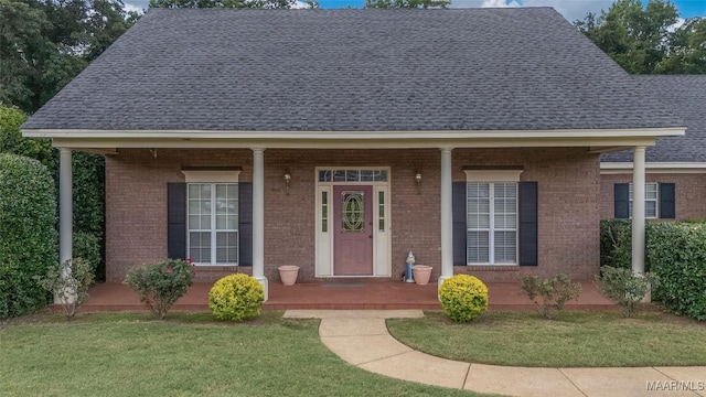 285 Cedar Ridge Dr, Wetumpka, AL 36093 - view of front facade featuring a shingled roof, brick siding, a front lawn, and a porch