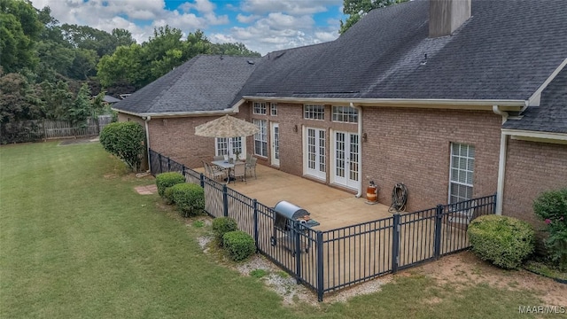 285 Cedar Ridge Dr, Wetumpka, AL 36093 - rear view of house with a patio, brick siding, french doors, a fenced backyard, and a shingled roof
