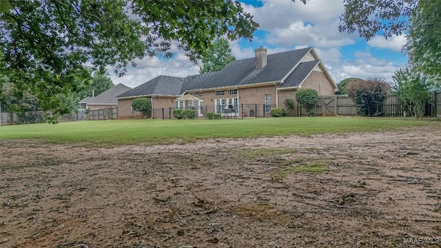 285 Cedar Ridge Dr, Wetumpka, AL 36093 - back of house featuring brick siding, a chimney, and a fenced backyard