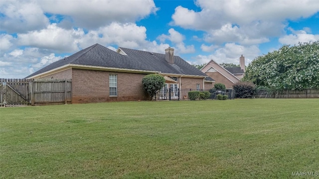 285 Cedar Ridge Dr, Wetumpka, AL 36093 - back of house featuring brick siding, a fenced backyard, and a chimney