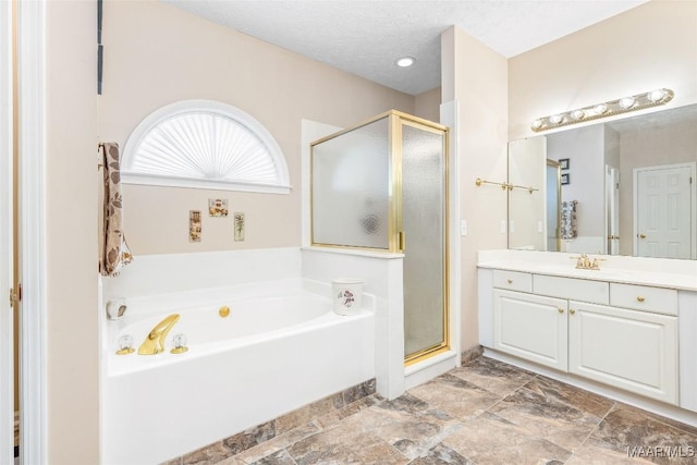 285 Cedar Ridge Dr, Wetumpka, AL 36093 - bathroom with vanity, a bath, a stall shower, and a textured ceiling