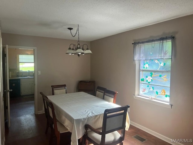 649 Partridge Ln, Prattville, AL 36067 - dining area with dark wood-type flooring, a textured ceiling, and a chandelier