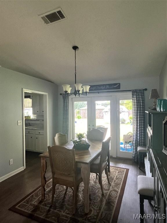 2607 Pine Tree Cir, Selma, AL 36701 - dining area featuring a chandelier and dark wood-style flooring