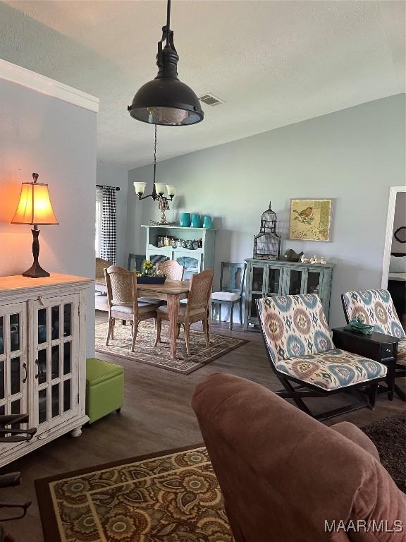 2607 Pine Tree Cir, Selma, AL 36701 - living room with wood finished floors, a chandelier, and lofted ceiling