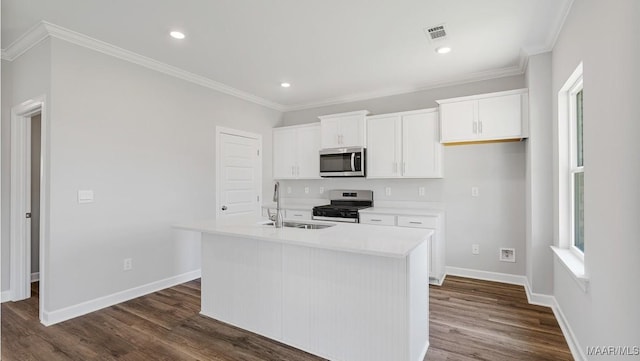 6028 Cunningham Trl, Montgomery, AL 36116 - kitchen with stainless steel appliances, white cabinets, a kitchen island with sink, dark wood-style floors, and light countertops