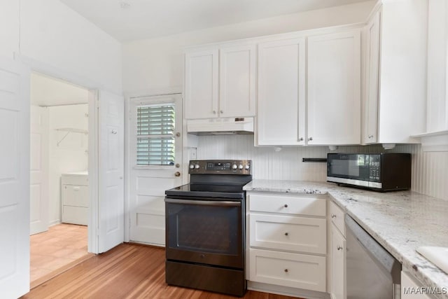 610 Ponce De Leon Ave, Montgomery, AL 36106 - kitchen with electric range oven, dishwashing machine, washer / dryer, under cabinet range hood, and white cabinetry