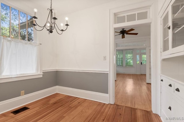 610 Ponce De Leon Ave, Montgomery, AL 36106 - unfurnished dining area with a chandelier, light wood finished floors, and ceiling fan