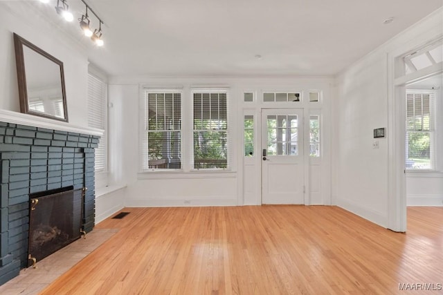 610 Ponce De Leon Ave, Montgomery, AL 36106 - foyer entrance featuring light wood-type flooring, a fireplace, rail lighting, and ornamental molding