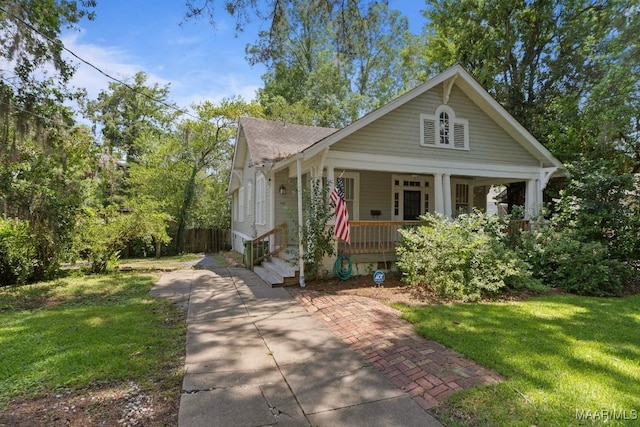 610 Ponce De Leon Ave, Montgomery, AL 36106 - bungalow-style house featuring a porch, a front lawn, and concrete driveway