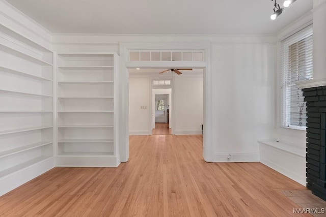 610 Ponce De Leon Ave, Montgomery, AL 36106 - unfurnished room featuring a brick fireplace, light wood finished floors, plenty of natural light, and crown molding