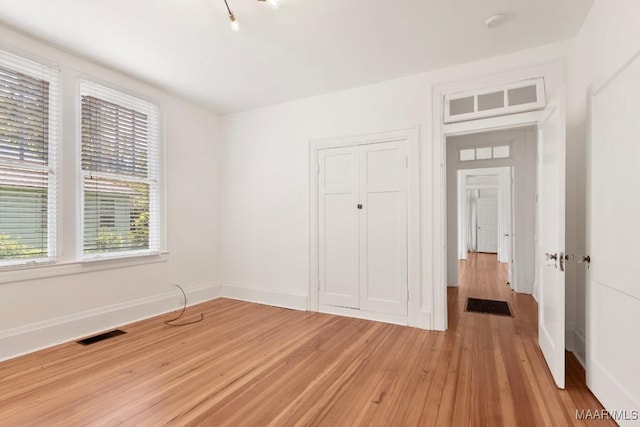 610 Ponce De Leon Ave, Montgomery, AL 36106 - unfurnished bedroom featuring light wood-style floors, multiple windows, and a closet